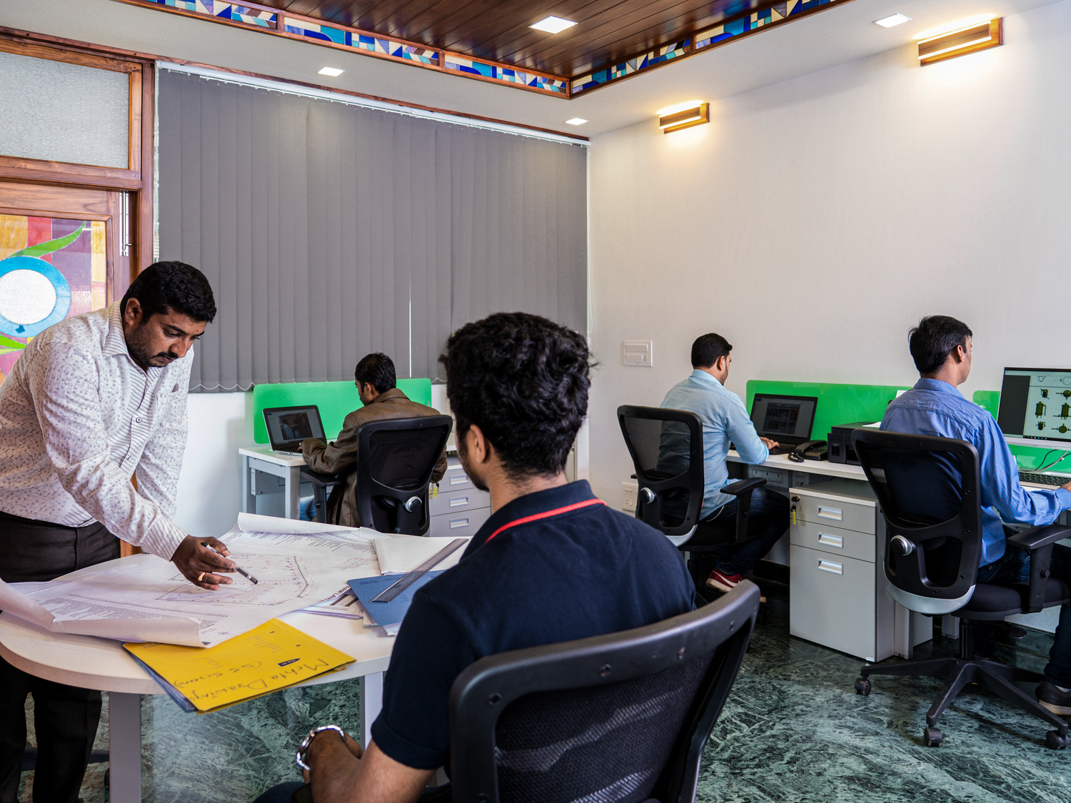 Team Members Working on Rain Water Harvesting Projects with Rainy Filters in the Office